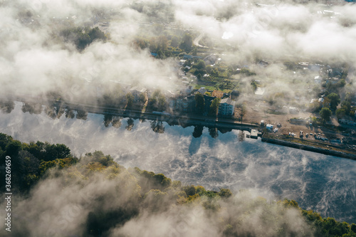 Airscape - The thick clouds are hovering over the city. The city-view with long bridge over the river, deep forest and dollhouses peeked out as the clouds hurried past