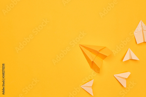 minimalism yellow paper planes on a yellow background. travel, flight, flat layer, copy space