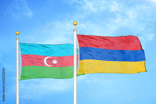 Azerbaijan and Armenia two flags on flagpoles and blue sky photo