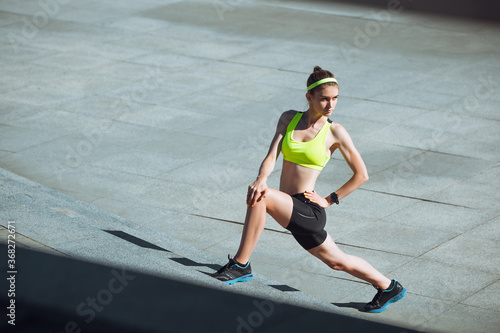 Motivation. Female runner, athlete training outdoors. Professional runner, jogger working out on the street. Concept of healthy lifestyle, sport, wellness, wellbeing, motion and action, activity.
