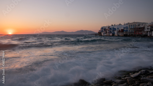 Panoramic The Little Venice district with old colorful houses by the sea in Mykonos Island at sunset, Cyclades, Greece. Greek landscape. Travel and tourism concept.