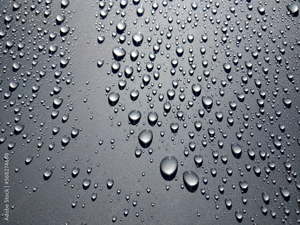 some raindrops on a surface as background some raindrops on a surface as background