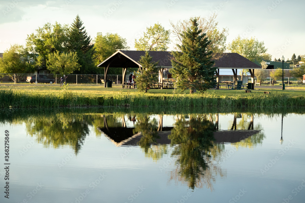 Picnic shelter at a lake with reflection in water. Picnic shelter at a lake with reflection in water.