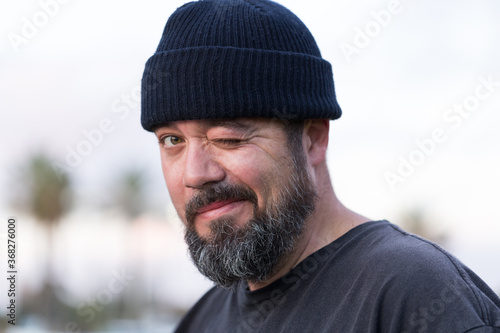 Bearded guy in beanie winking