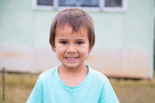 Smiling child outside home photo