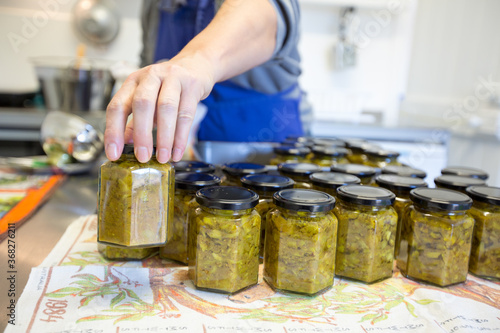 jars of pickle being filled in small commercial kitchen photo