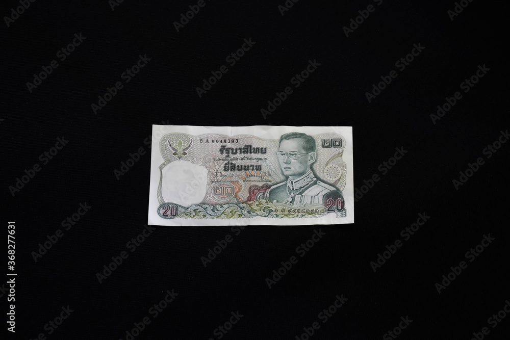 July30,2020 Old version 20 baht banknote with black background in Bangkok Thailand July30,2020 Old version 20 baht banknote with black background in Bangkok Thailand