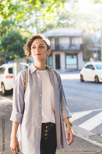 young woman walking on the footpath in inner-city suburb photo