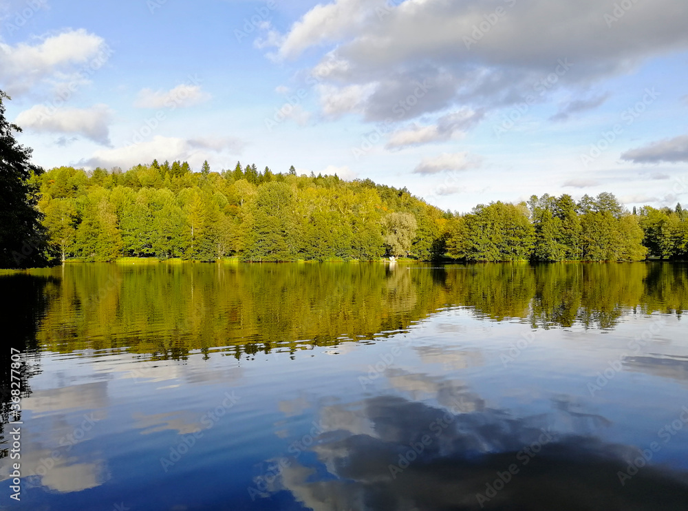 Beautiful natural landscape with reflection in the water. Early autumn in Finland. Beautiful natural landscape with reflection in the water. Early autumn in Finland.