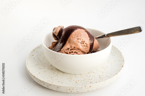 Bowl of chocolate ice cream with rich chocolate sauce. photo