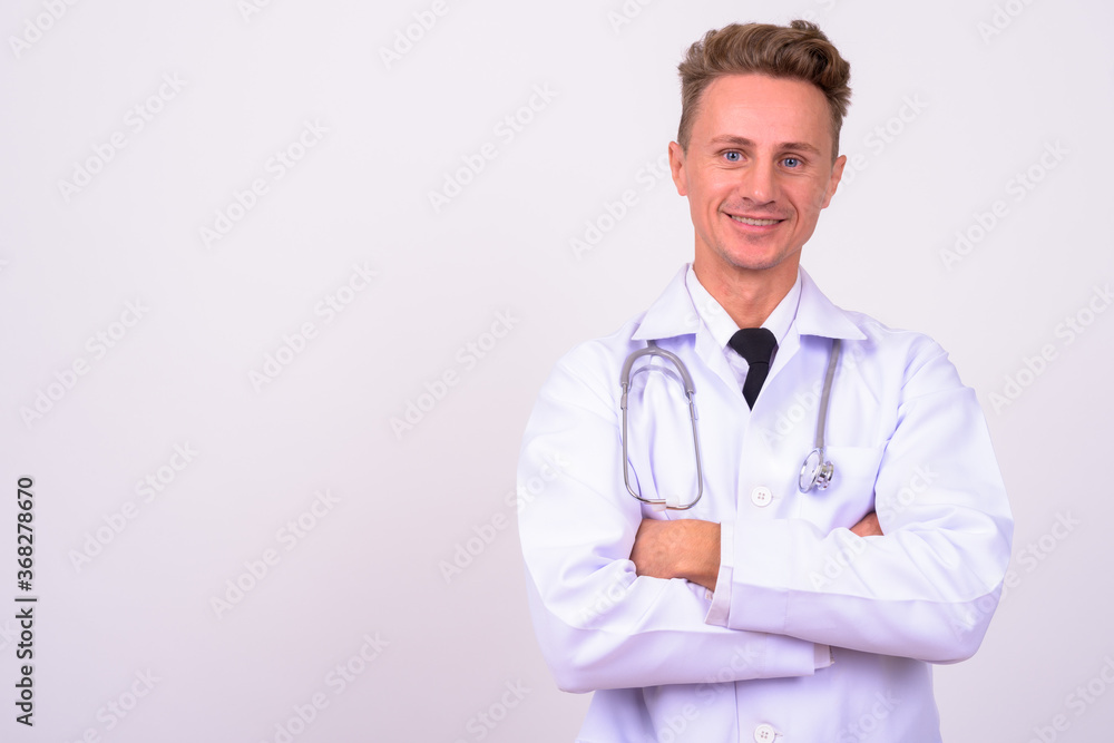 Portrait of happy handsome man doctor with blond curly hair Portrait of happy handsome man doctor with blond curly hair