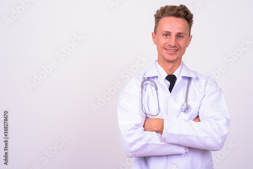 Portrait of happy handsome man doctor with blond curly hair