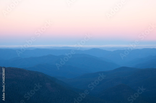 View of mountain ranges at sunset photo