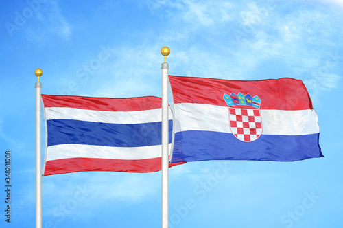 Thailand and Croatia two flags on flagpoles and blue sky