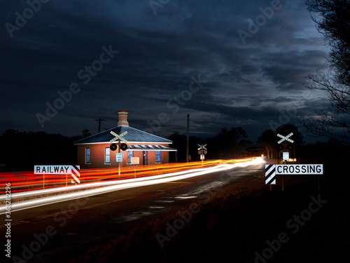 Cars crossing a railway crossing at night photo