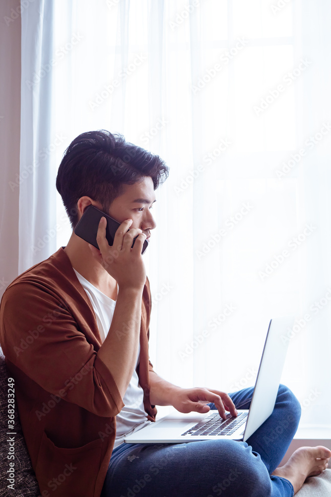 Young man wearing casual clothes and talking on mobile phone Young man wearing casual clothes and talking on mobile phone