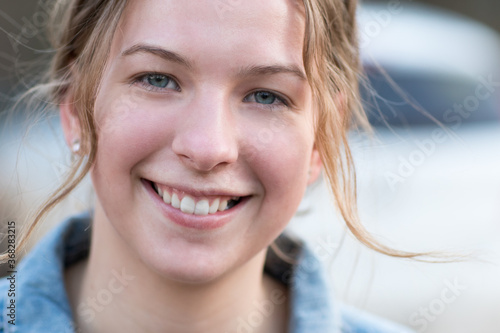 Smiling teenage girl with flyaway hair photo