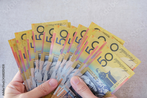 Hands holding fifty dollar notes, Australian money