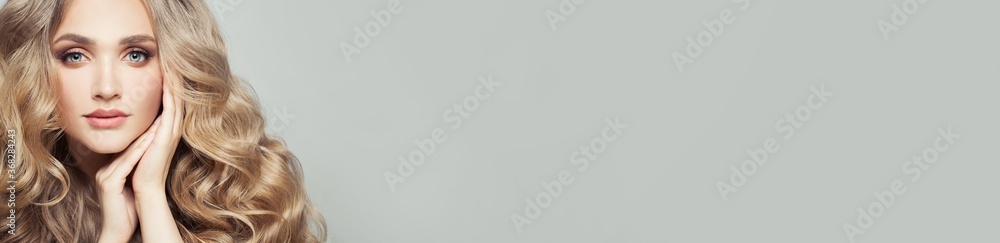 Pretty woman with blonde curly hair and natural makeup on white banner background, beautiful face close up Pretty woman with blonde curly hair and natural makeup on white banner background, beautiful face close up
