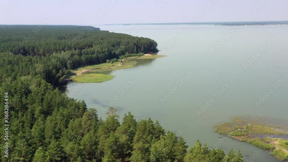 Aerial video of forest boggy lake in the Karakansky pine forest near the shore of the Ob reservoir. Aerial video of forest boggy lake in the Karakansky pine forest near the shore of the Ob reservoir.