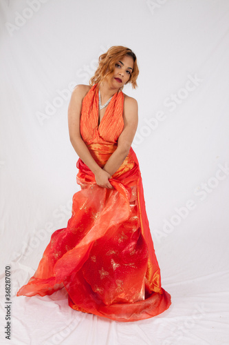 Lovely Hispanic woman in a flowing orange dress