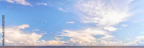 Panoramic cloudscape over sea at bright sunny day