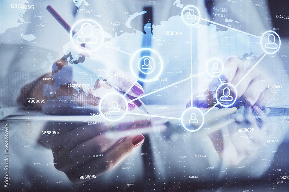 Social network theme hologram over hands taking notes background. Concept of global international people connect. Double exposure Social network theme hologram over hands taking notes background. Concept of global international people connect. Double exposure