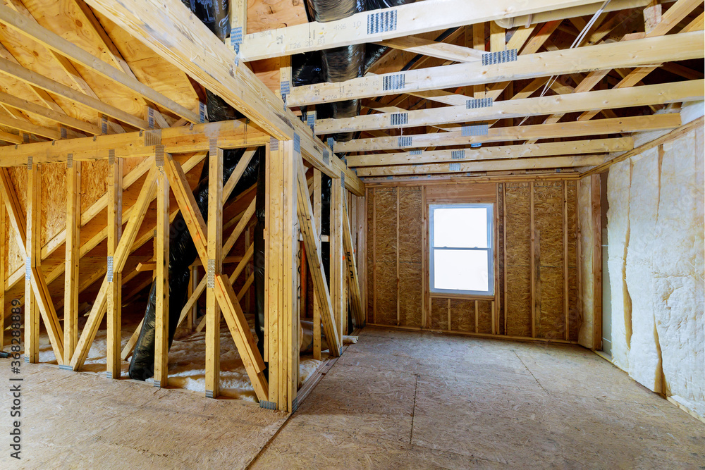 House in unfinished under construction insulation foam the wall roofing of a attic House in unfinished under construction insulation foam the wall roofing of a attic