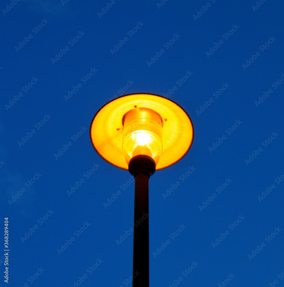 Gelblich leuchtende Straßenlaterne am Abend. Gelblich leuchtende Straßenlaterne am Abend.