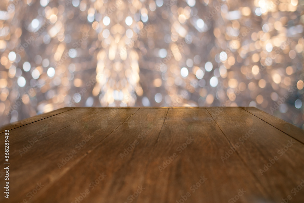 Abstract Creative Christmas blurred background with empty wood table in front of beautiful bokeh. Abstract Creative Christmas blurred background with empty wood table in front of beautiful bokeh.