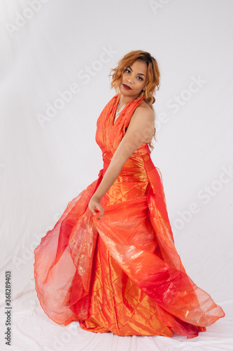 Lovely Hispanic woman playing with her dress