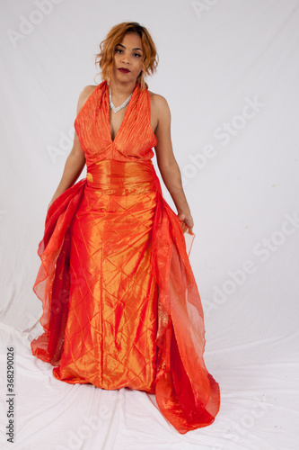 Lovely Hispanic woman in a flowing orange dress