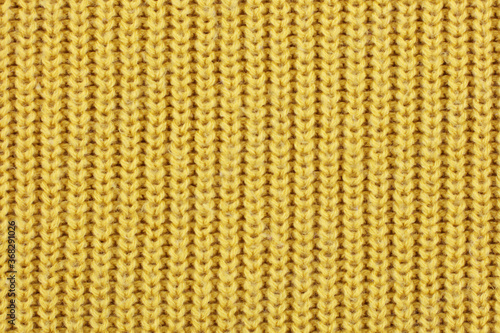 Yellow knitted ribbed wool textile background texture