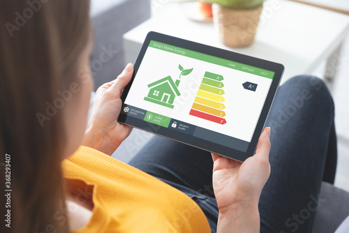 Photos Energy efficiency mobile app on screen, eco house