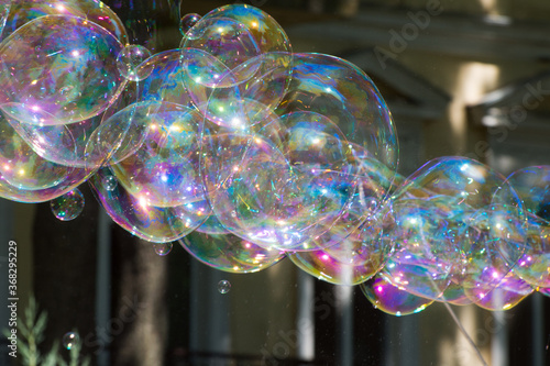 Large soap bubbles fly in the air. Soap bubbles multicolor background.