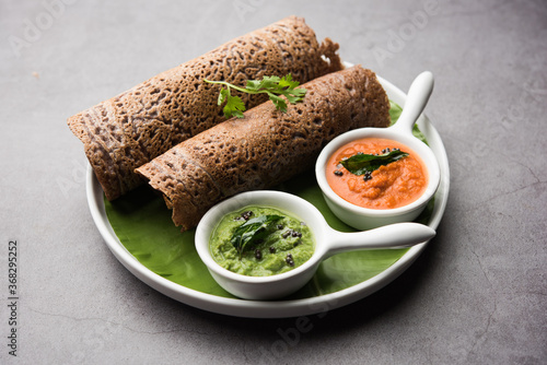 Ragi Dosa made using batter of Finger Millet is a healthy Indian breakfast served with chutney photo