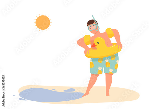 A man with a lifebuoy in oversleeves and a swimming mask touches the water with his foot. photo