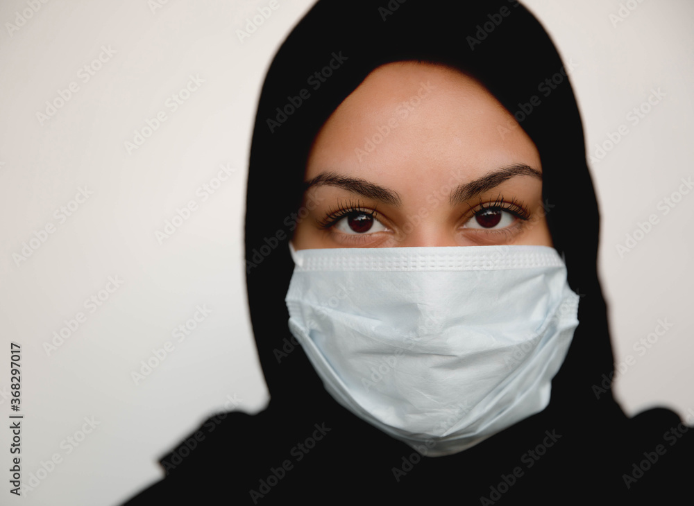 portrait of a young woman wearing mask, and head covering portrait of a young woman wearing mask, and head covering