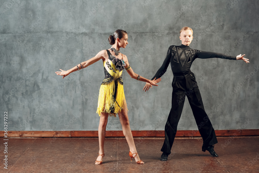 Fototapeta premium Young couple dancers dancing ballroom dance cha-cha-cha