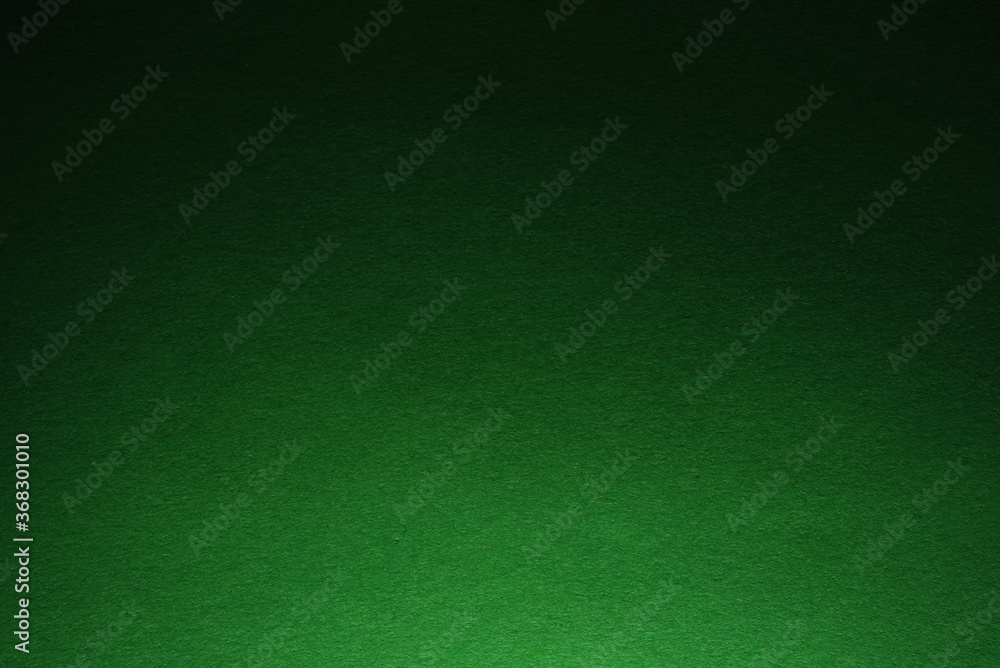 Fototapeta premium Green paper texture with light from the bottom side