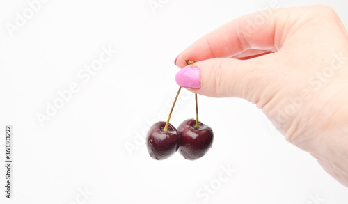 woman holding two cherries