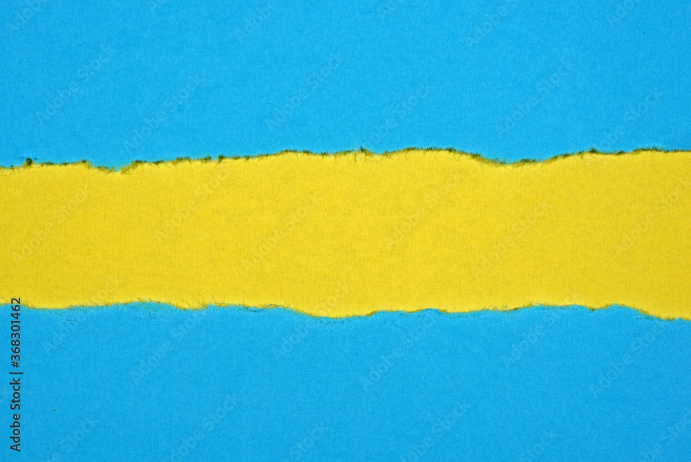 Obraz premium Ripped in blue paper on yellow background