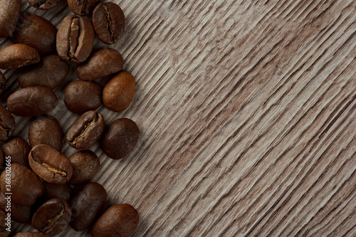 Coffee beans laid out on a background of wood