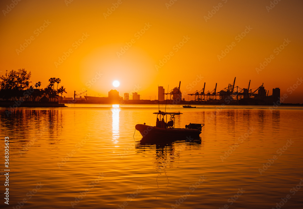 Fototapeta premium fishing boat at sunset sunrise florida miami sun summer water 
