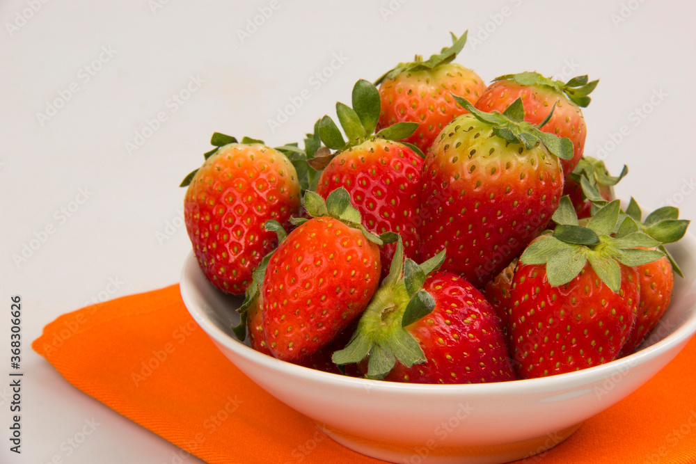 Red fresh strawberry in a bowl on white background. Red fresh strawberry in a bowl on white background.