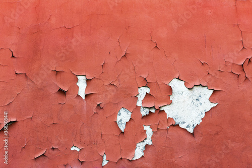 Abstract creative background of chaotic strokes of old cracked paint on concrete wall. Old surface with traces of paint, weathered, scratches and cracks for design