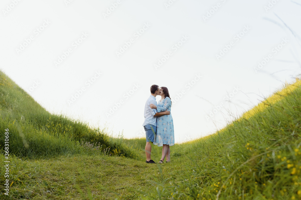Portrait of a pregnant woman with her boyfriend. Happy couple expecting a baby, young family concept. High quality photo