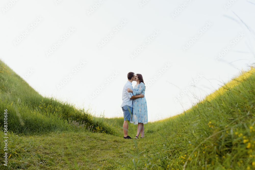 Portrait of a pregnant woman with her boyfriend. Happy couple expecting a baby, young family concept. High quality photo Portrait of a pregnant woman with her boyfriend. Happy couple expecting a baby, young family concept. High quality photo