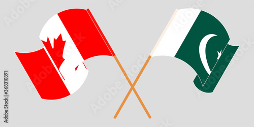 Crossed and waving flags of Pakistan and Canada
