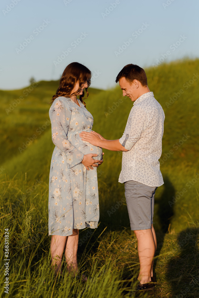 Portrait of a pregnant woman with her boyfriend. Happy couple expecting a baby, young family concept. High quality photo Portrait of a pregnant woman with her boyfriend. Happy couple expecting a baby, young family concept. High quality photo